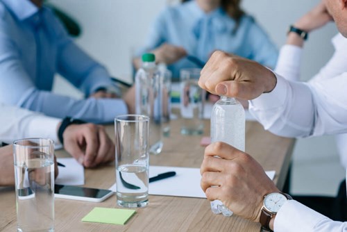 meeting table filled with bottles of water 