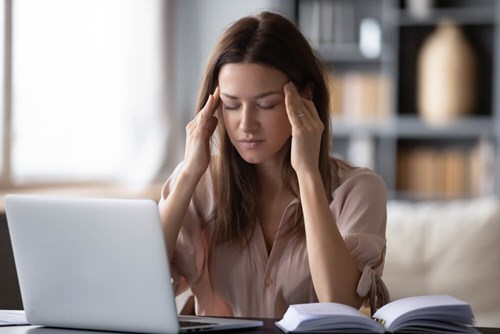 A women rubbing her head with boredom.