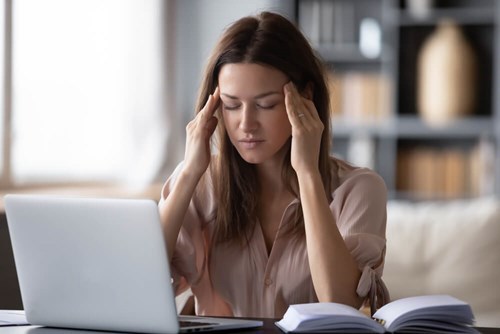 A women rubbing her head with boredom.