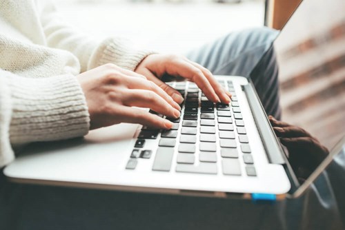 Typing on a laptop